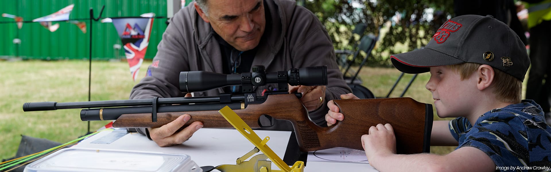 A young shot being coached with their air rifle