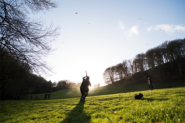 A shooter taking aim in a field