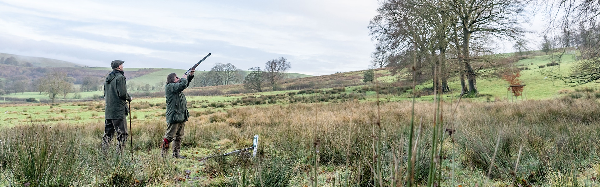 A pair of game shooters in a field