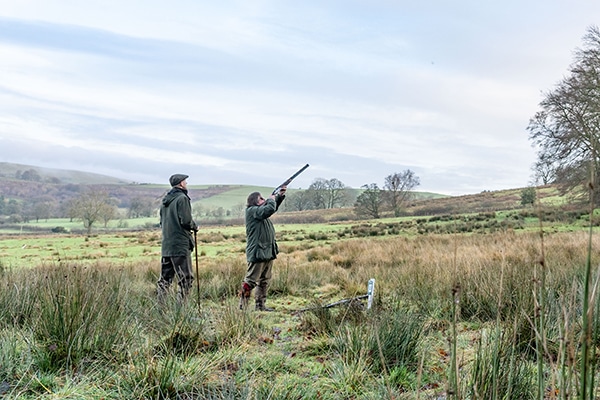 A pair of game shooters in a field