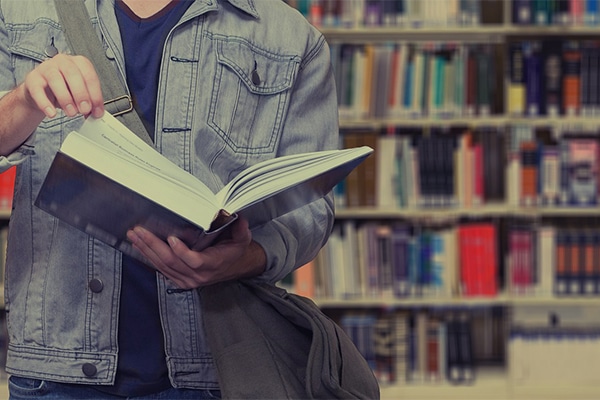 A man reading a book in a library