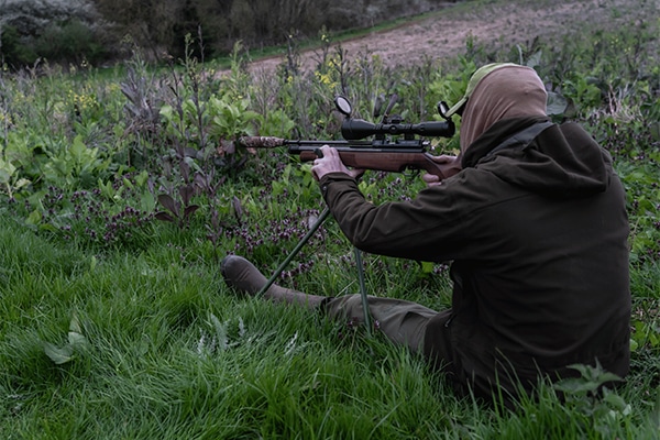 A rifle shooter sitting down