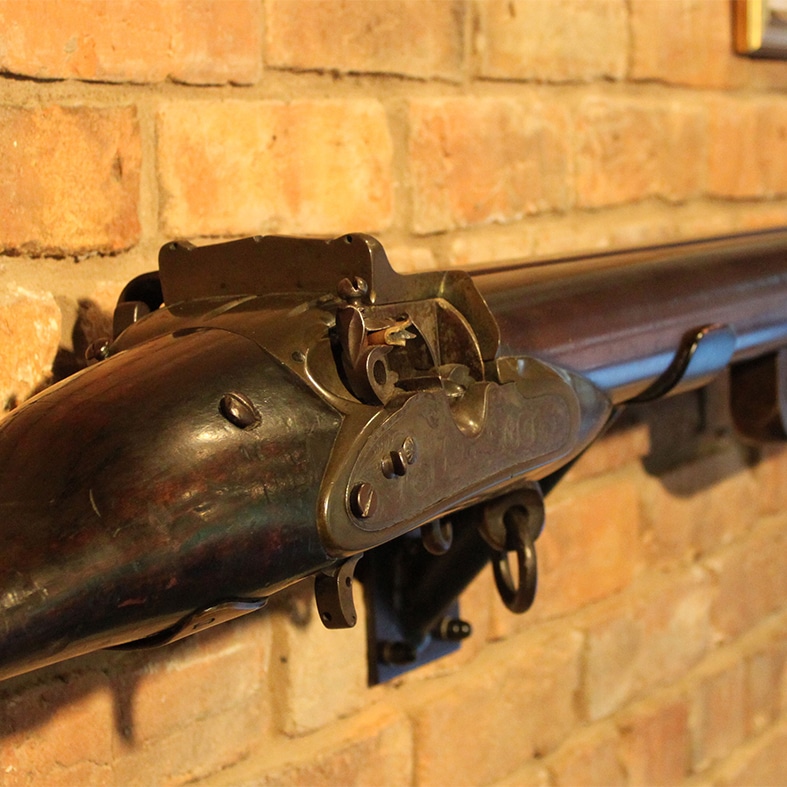 An antique firearm hung on a wall
