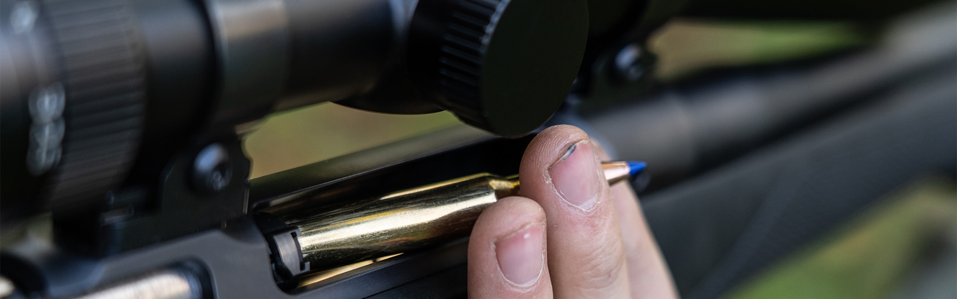 A bullet being loaded into a rifle