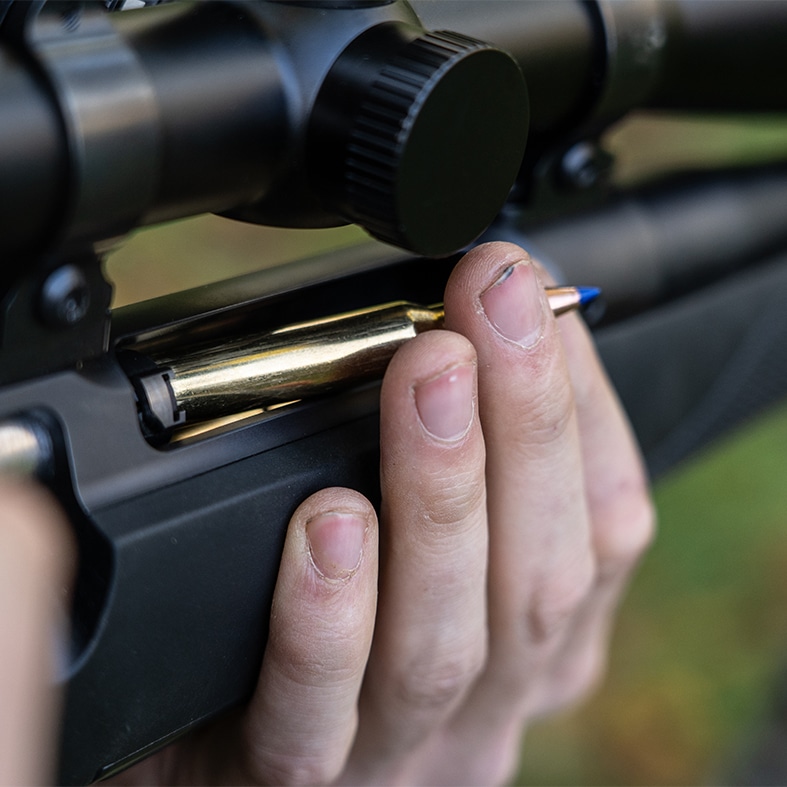 A bullet being loaded into a rifle