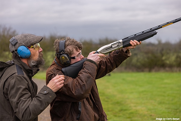 A young shot holding a shotgun