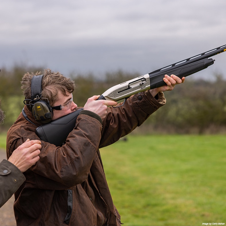 A young shot holding a shotgun
