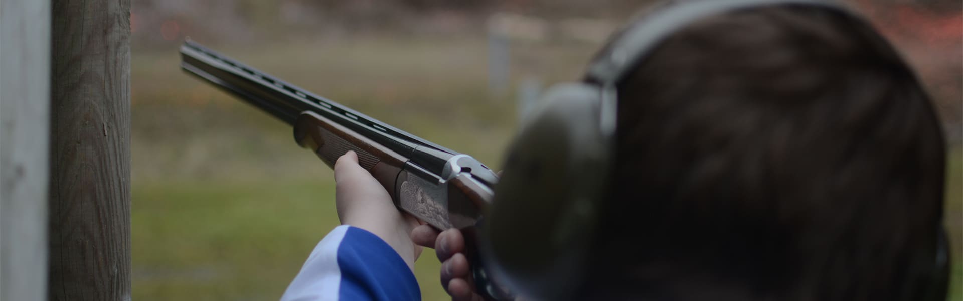 A young shot holding a shotgun