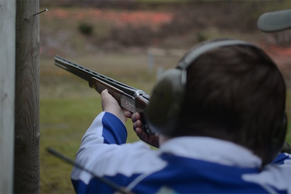 A young shot holding a shotgun