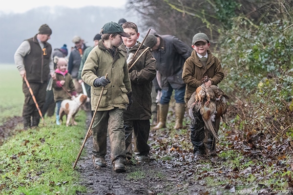 Young shooters walking together along a country land