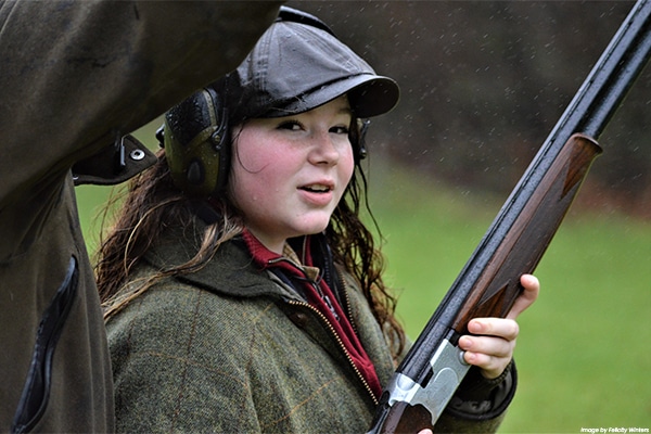 A young shot holding a shotgun