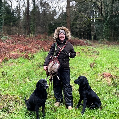 Toni Paull and two black labradors