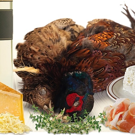 A pheasant carcass on a dinner table with side dishes