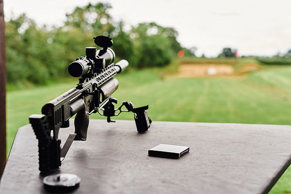 An air rifle aiming down a range