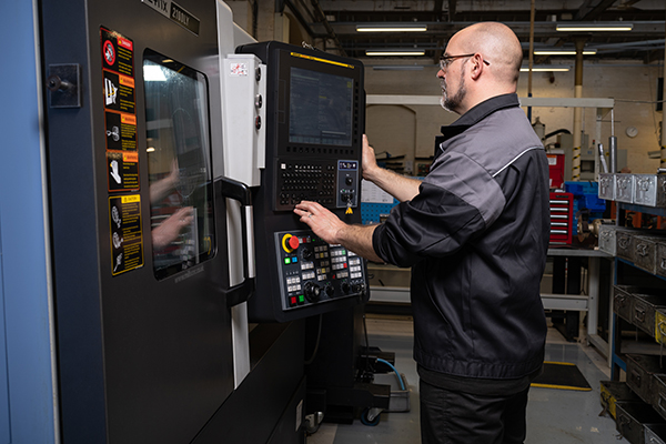 A CNC lathe being programmed to precision-machine BSA barrels