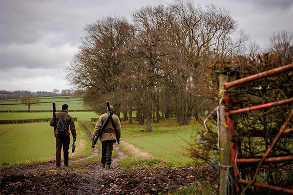 Two shooters walking along a path