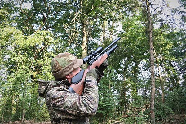 An airgun shooter aiming down the sight of their rifle