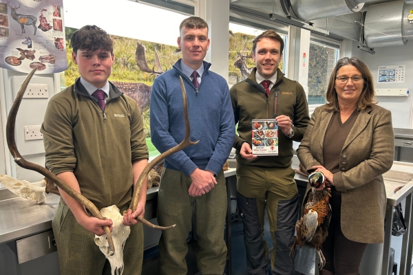 BASC Scotland Director Peter Clark with Tayside and Grampian Moorland Group coordinator Deirdre Falconer showing the students how to prepare the meat.