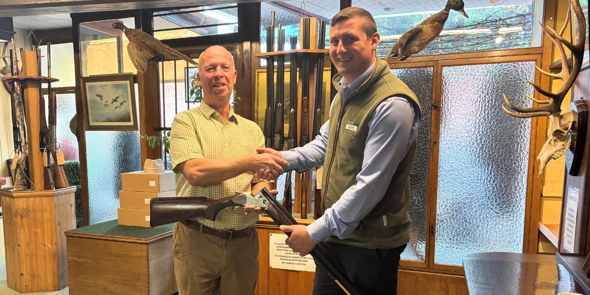 Melvyn Bowers receiving gun draw prize