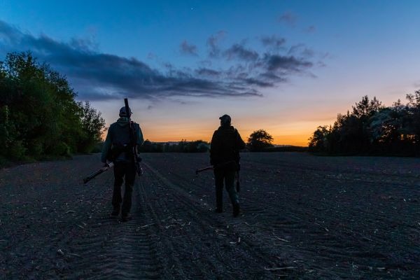 Two night shooters walking